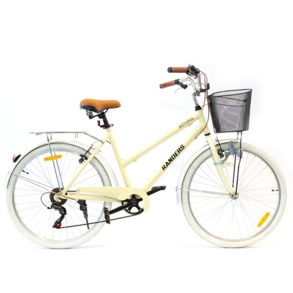 Bicicleta de paseo. Mujer. Con cambios. En color beige con detalles en marrón y plateado. Se visualiza el canasto en la parte frontal, un porta equipaje, en la parte trasera.